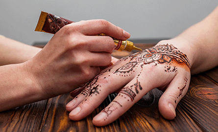 some getting their hand painted with henna.