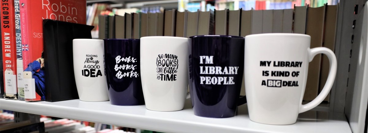 Mugs in a line of a shelf