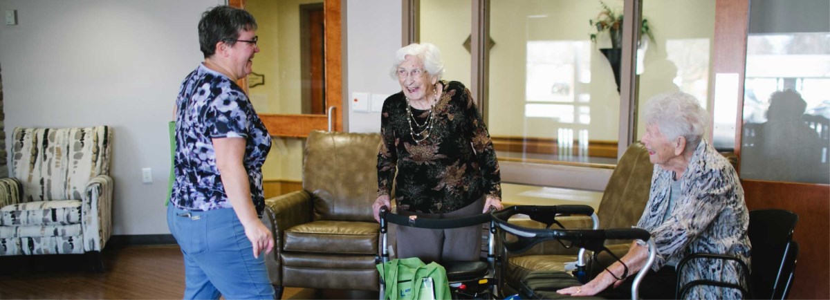 Senior citizens sitting with walkers. 