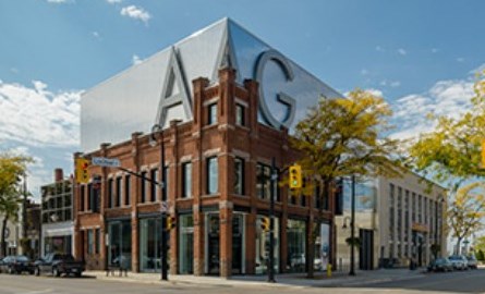 Front of red brick building on a street corner.