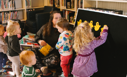 Children putting felt animals on felt board.