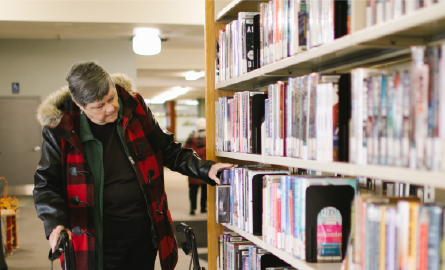 Woman browsing books in a library.