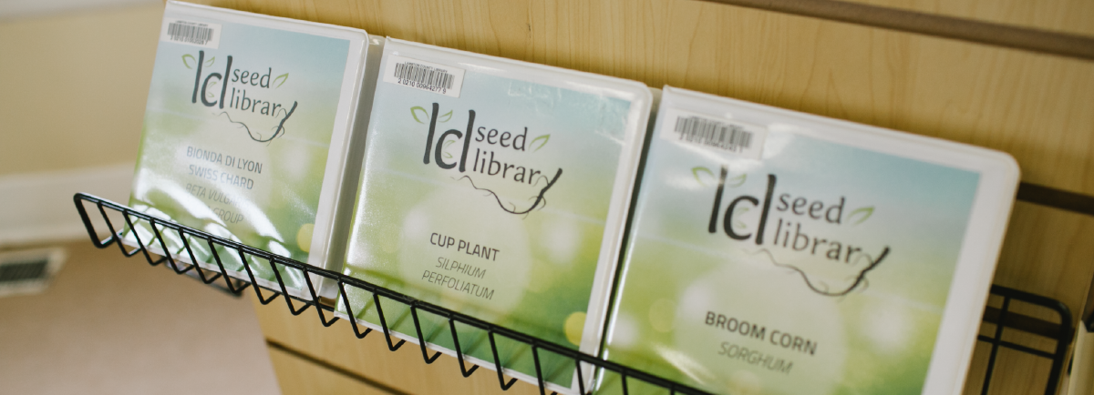 Seed Library containers displayed on a rack. 