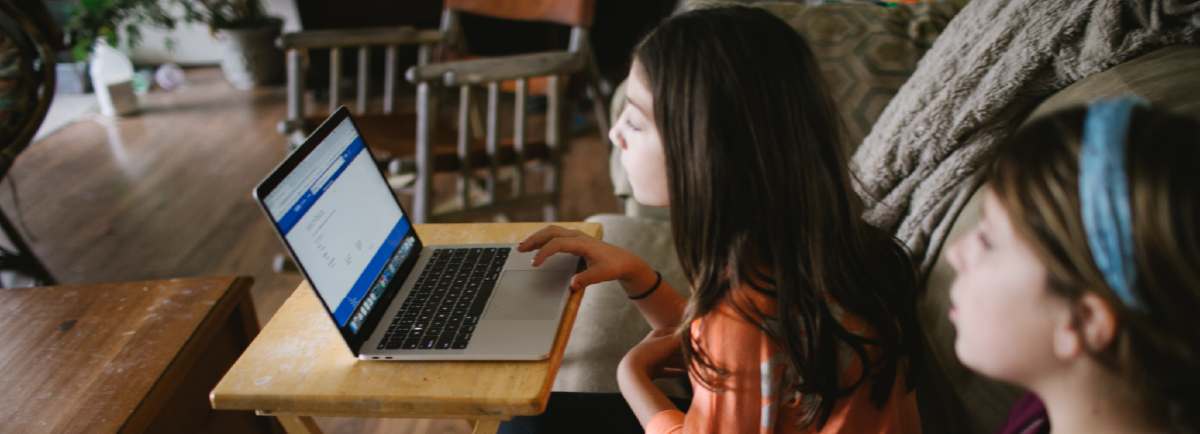 Two girls watching looking at a laptop. 