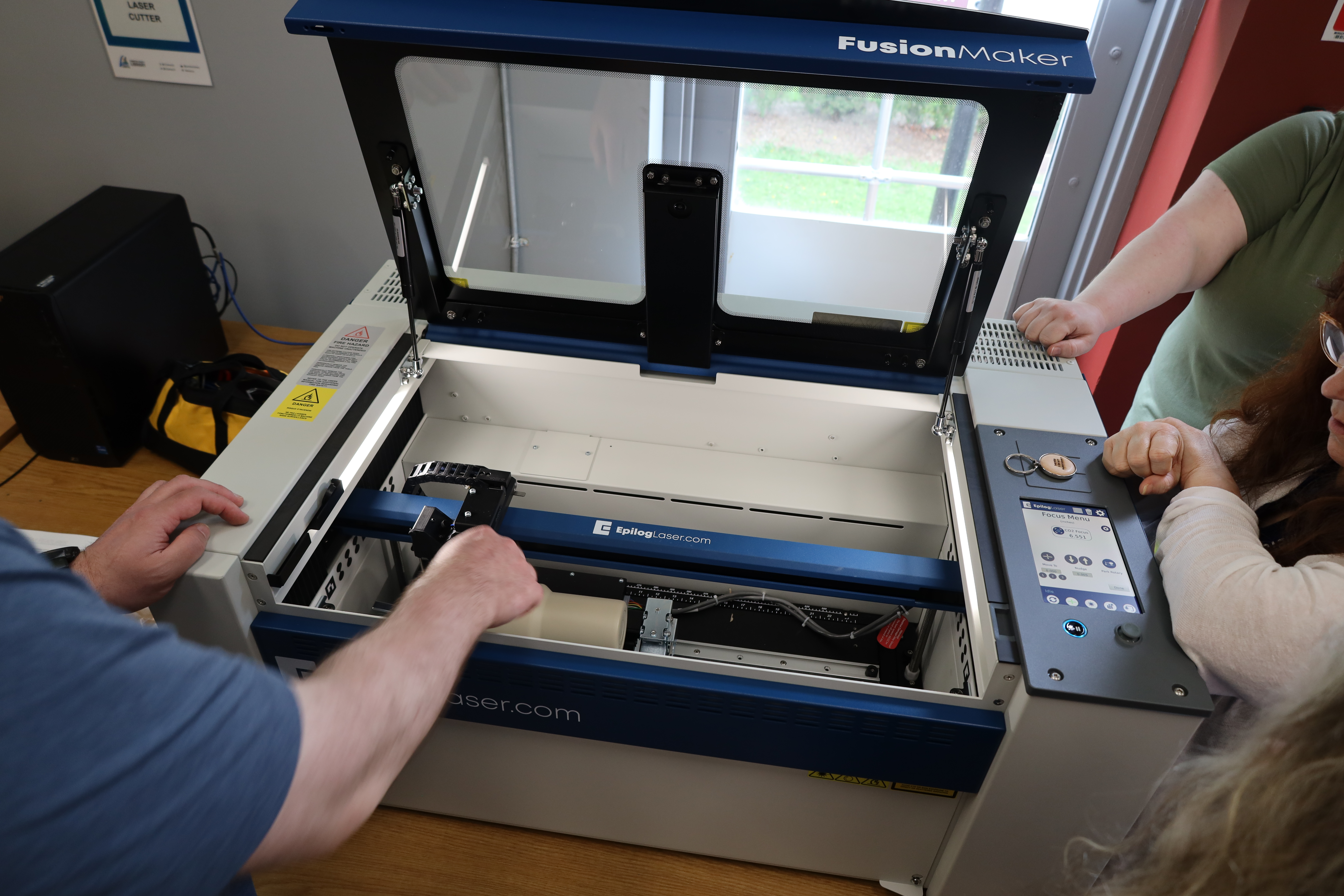 Laser cutter sitting on table. 