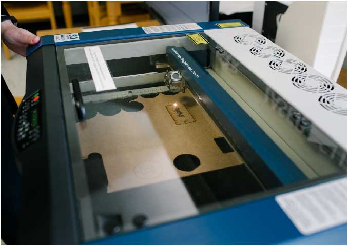 Laser cutter sitting on table. 