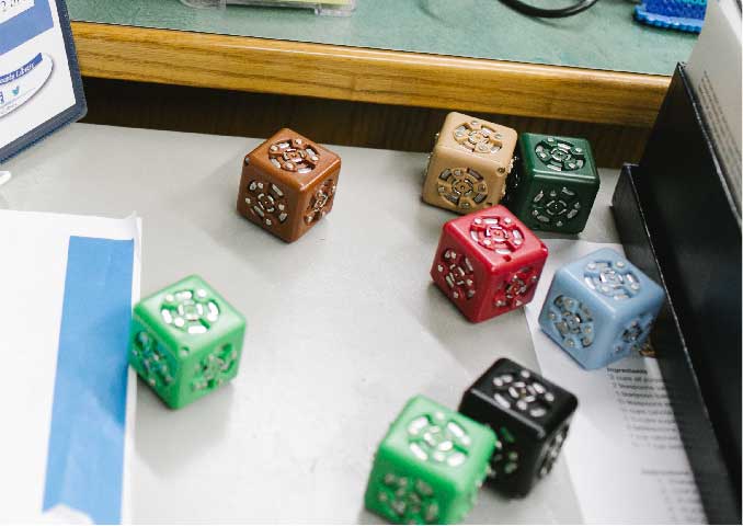 Small square robotics sitting on table.