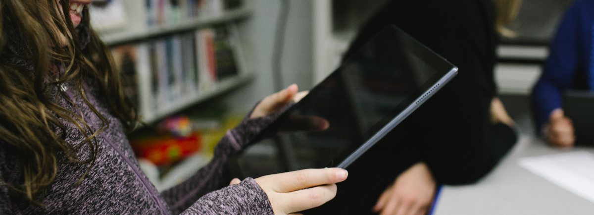 Girl holding tablet.