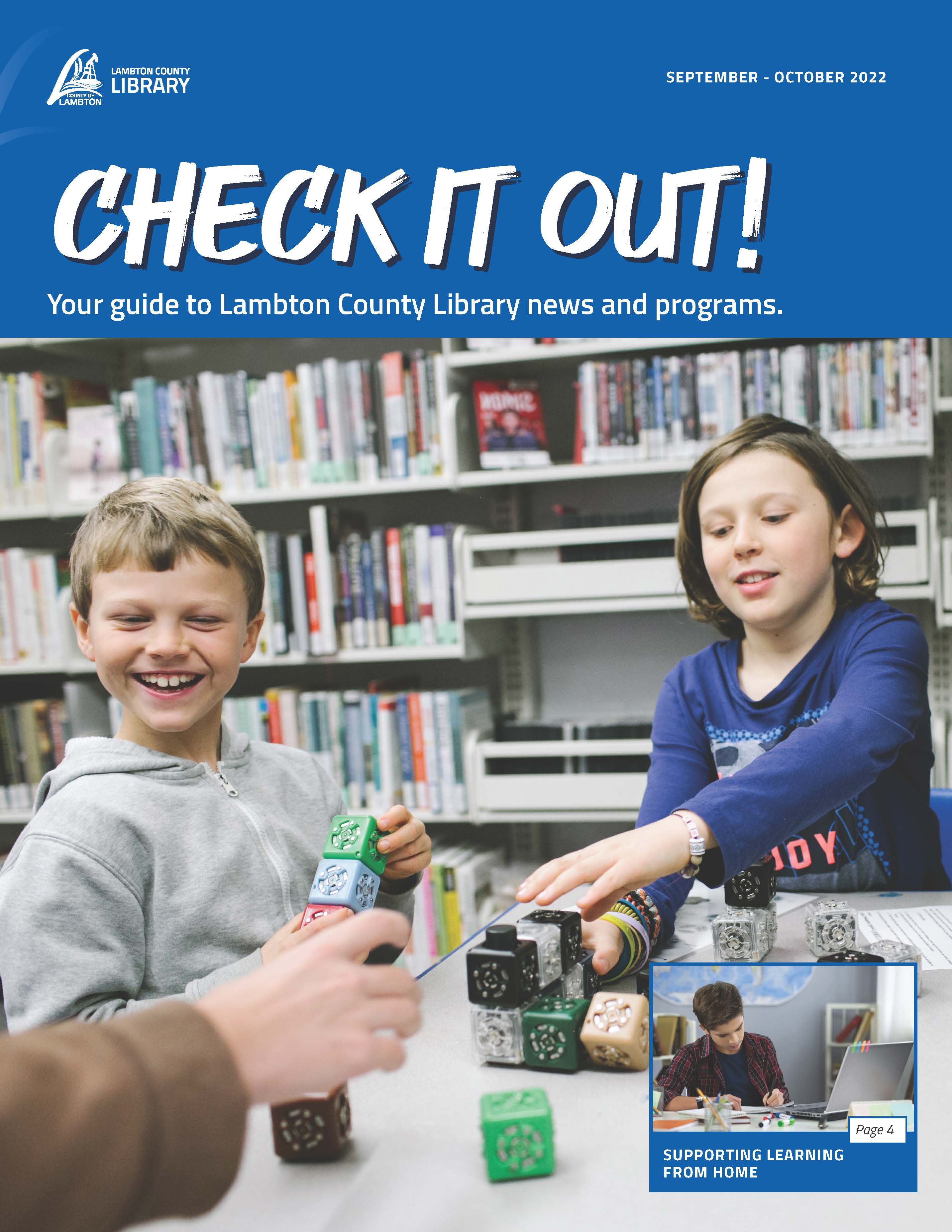 Two kids playing with robotics at a library.