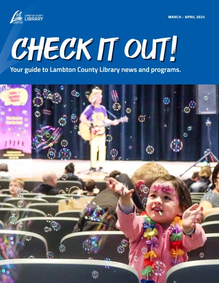 Cover of 'Check it Out!' featuring a child popping bubbles during Dan the Music Man's concert at Sarnia Library Theatre