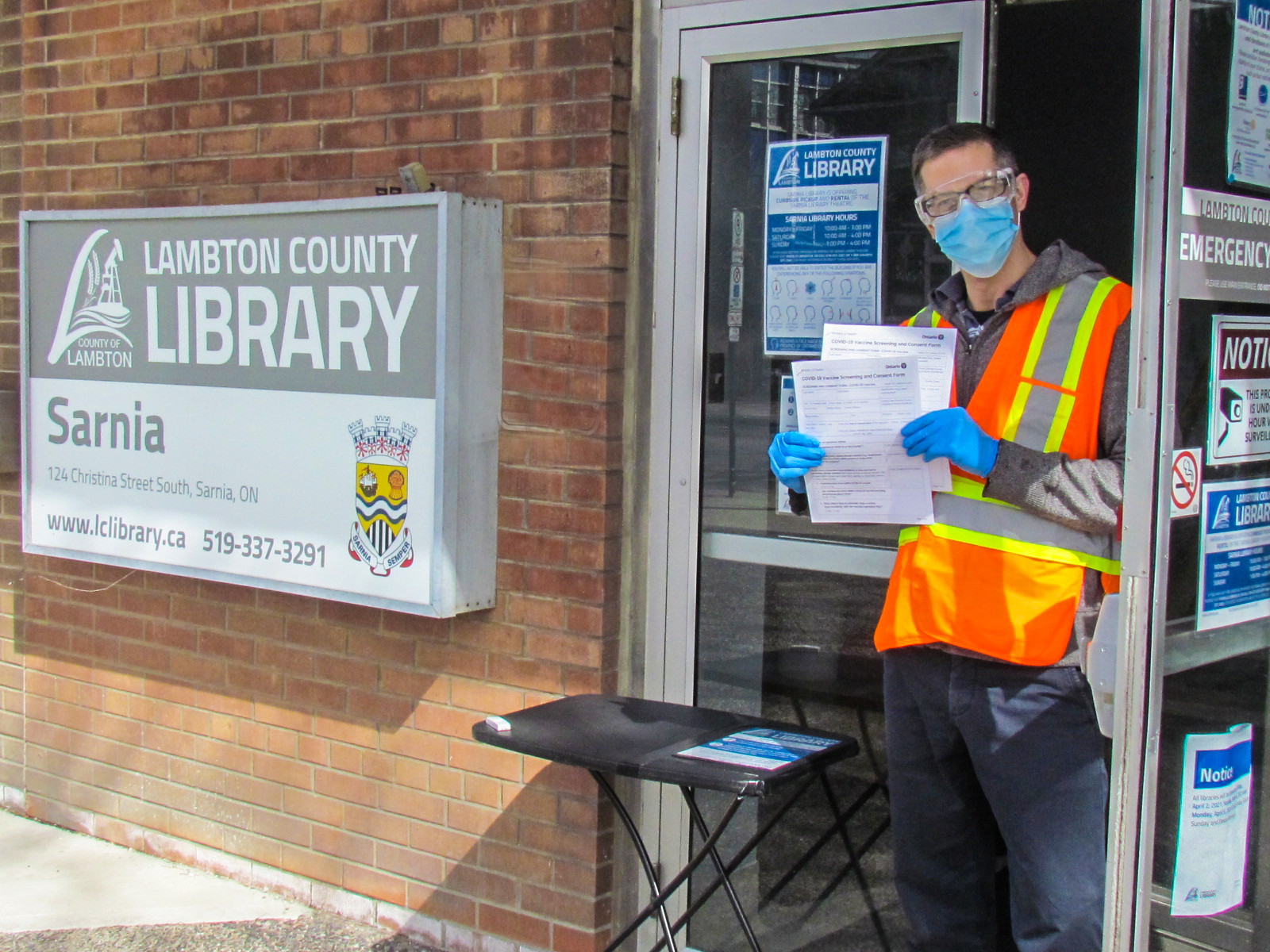 Staff member holding forms