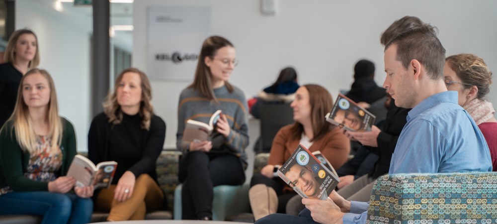 Group of people sitting and reading.