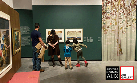 family touring an art gallery with green walls and art hung up.
