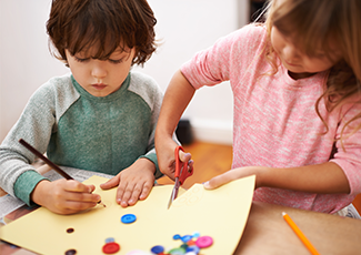 Kids crafting with paper and beads