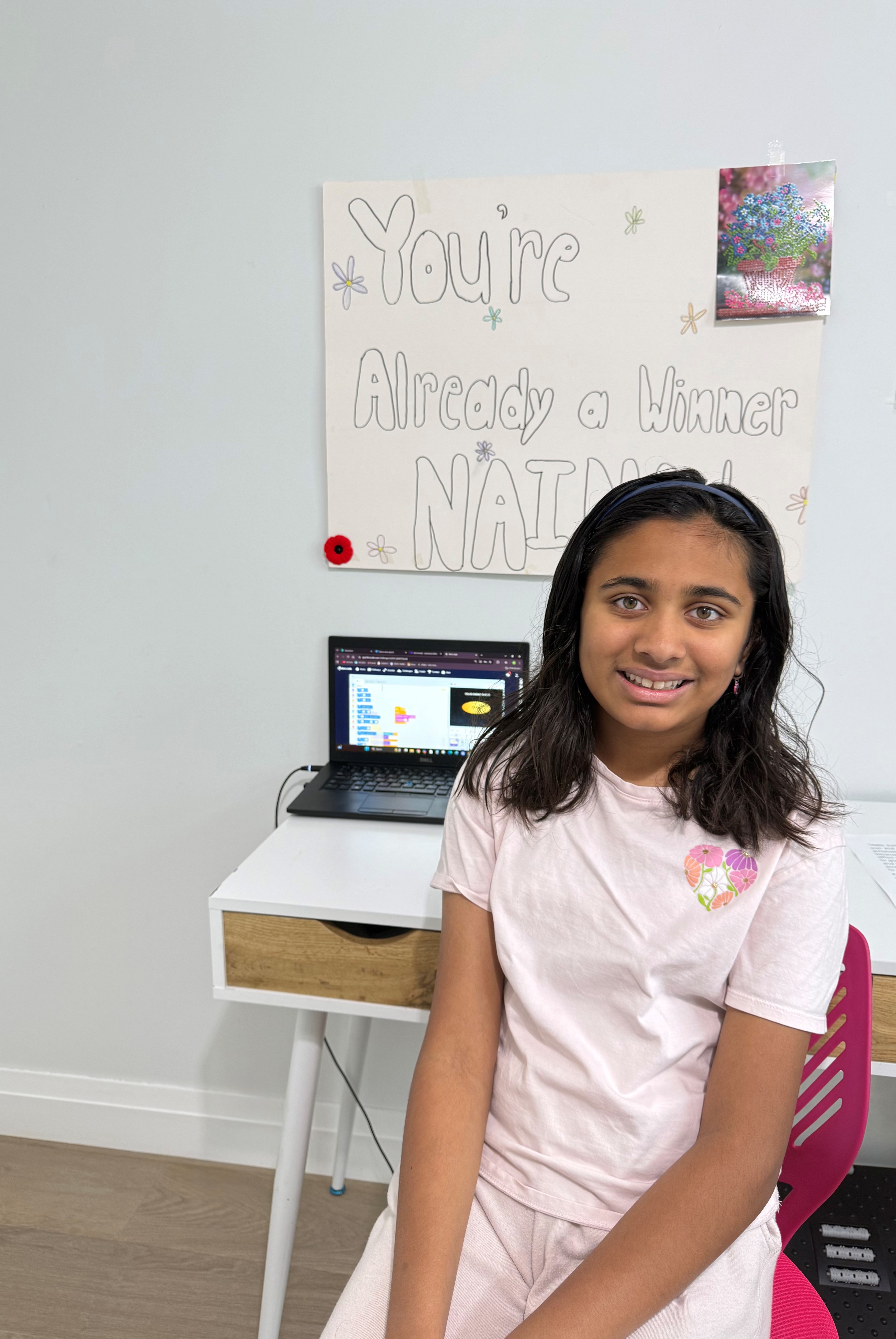 Naina Patel in front of laptop with winning game 