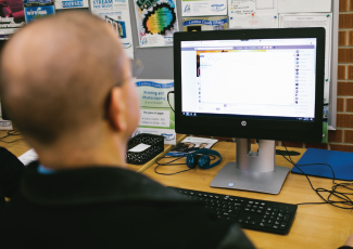 Person sitting in front of a computer.