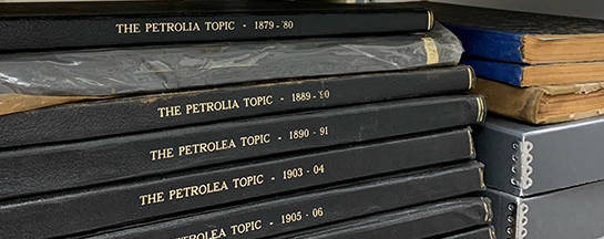 stack of Petrolia Topic books that hold old issues of newspapers