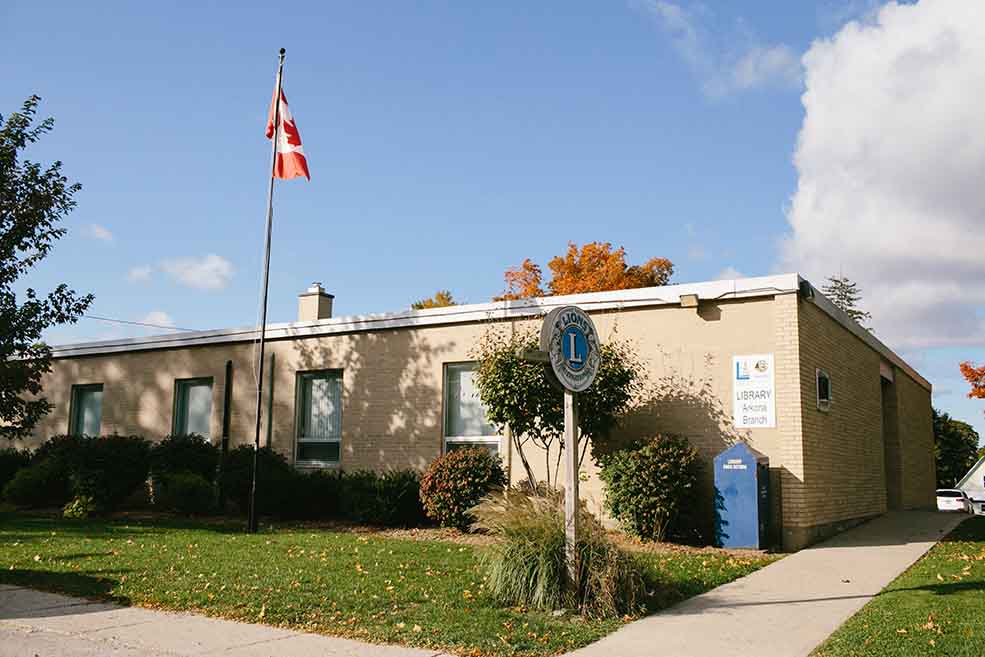 Building with flag pole in front yard. 