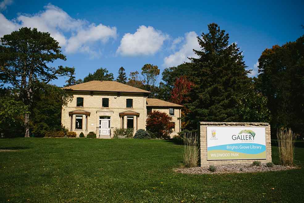 Yellow Brick building with large front yard. 