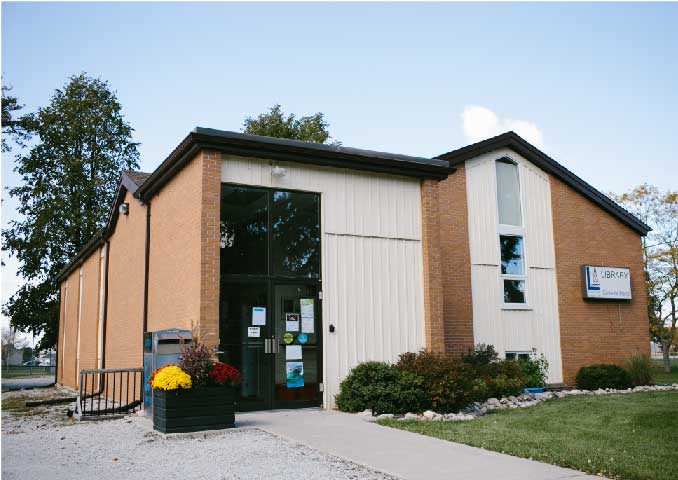 Brown brick building with grass front yard. 