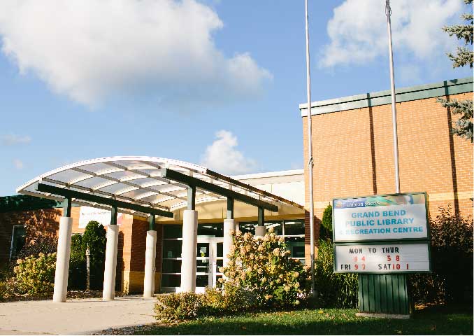 Red brick building with walkway. 