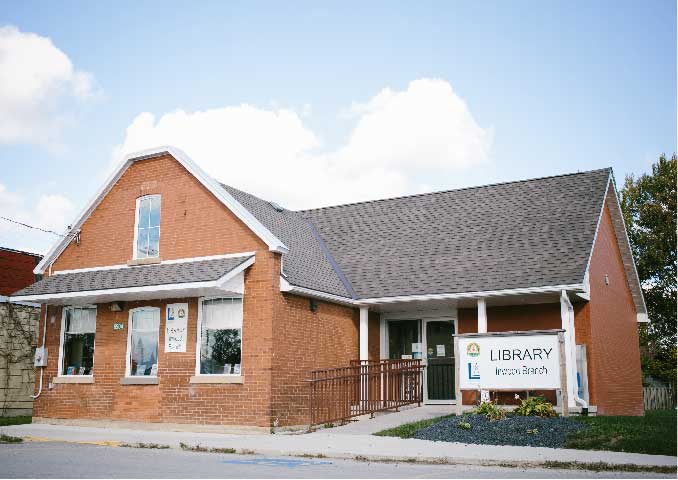 Red brick building with porch. 